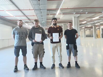 Zweiter Bildungsweg vier Männer in einer Halle